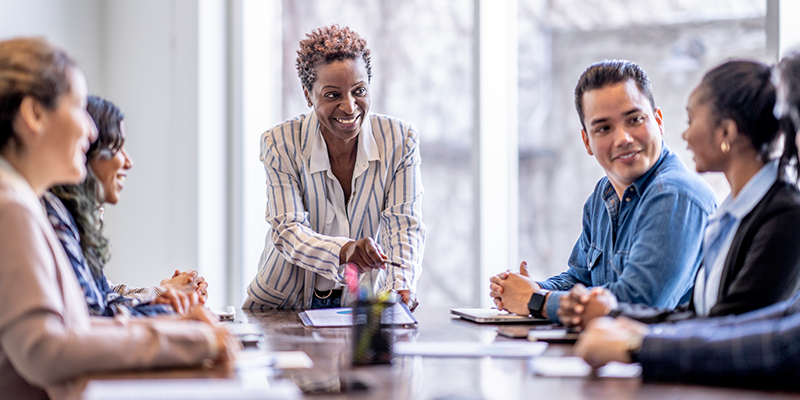 Black woman guiding a leadership discussion with health care professionals