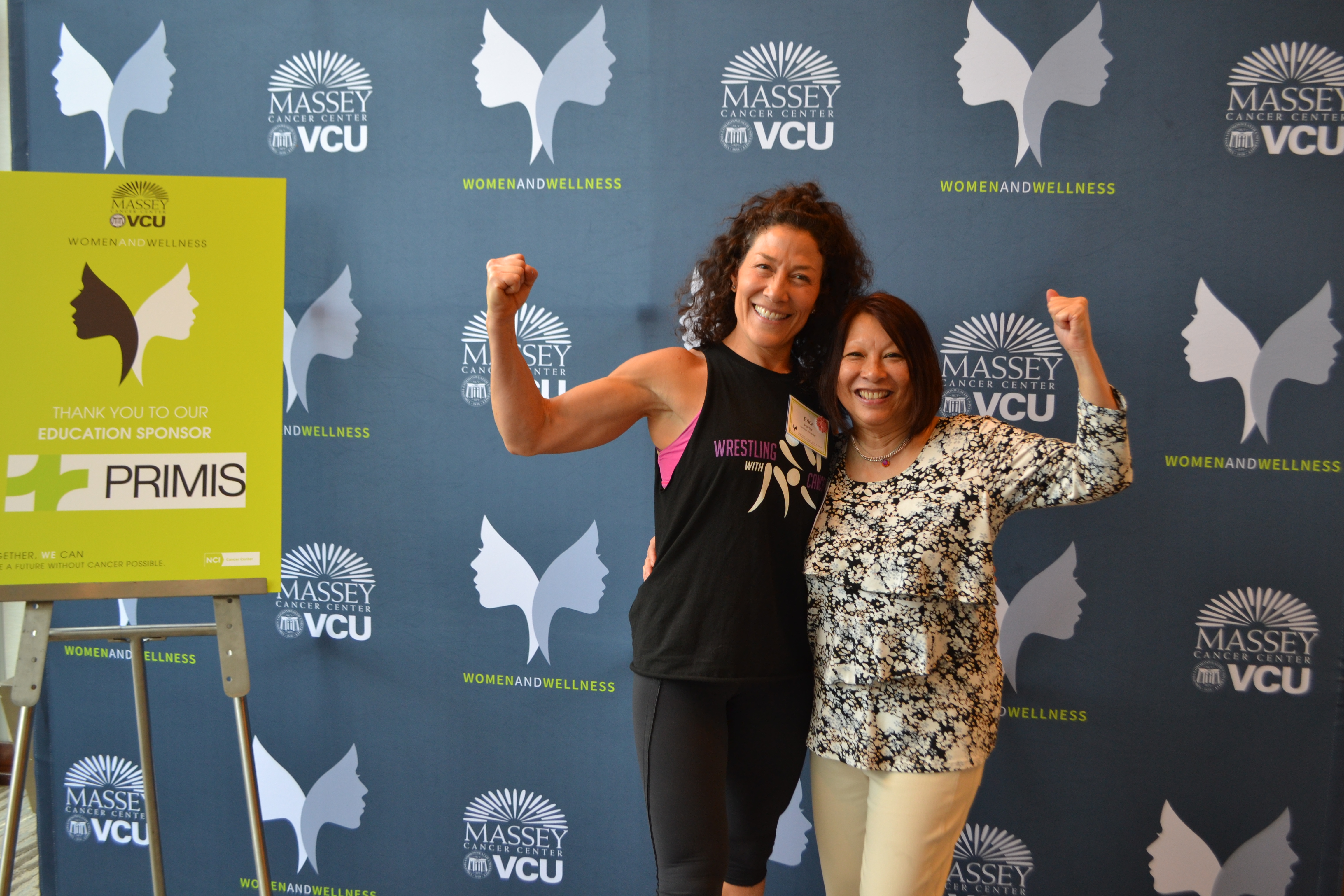 Women in Wellness event Participants Posing in Front of Background