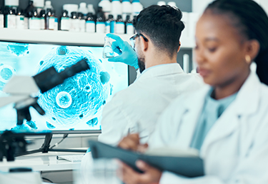 Students in laboratory working at a microscope