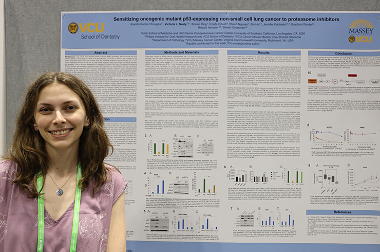 Neely pictured at AACR poster session