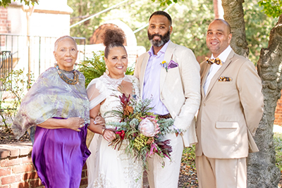 Boone (center left) and husband Eric Clay (center right) following their wedding ceremony Sept. 16, 2023. Pictured with Jean Patterson Boone, mother of the bride (left), and Raymond H. Boone Jr., brother of the bride (right). Photo credit: Samia Minnicks Photography.