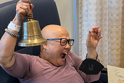 Boone rings a bell at the VCU Health Adult Outpatient Pavilion to celebrate her completion of chemotherapy on Dec. 14, 2023.