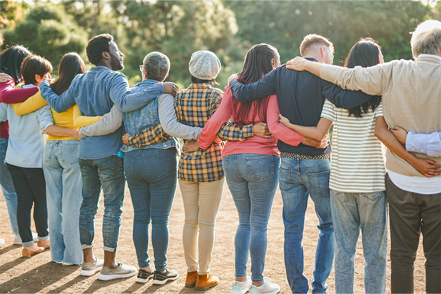 Group of diverse community members standing arm in arm looking away