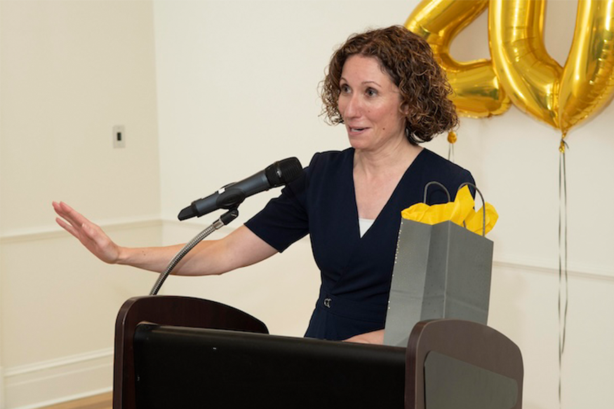 Dr. Noreika presenting at a podium