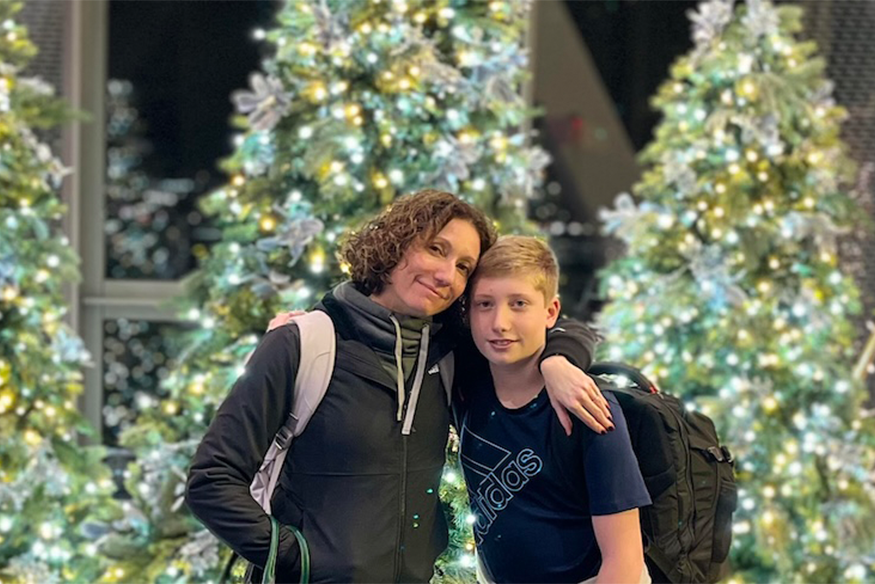 Dr. Noreika pictured with her son in front of christmas trees