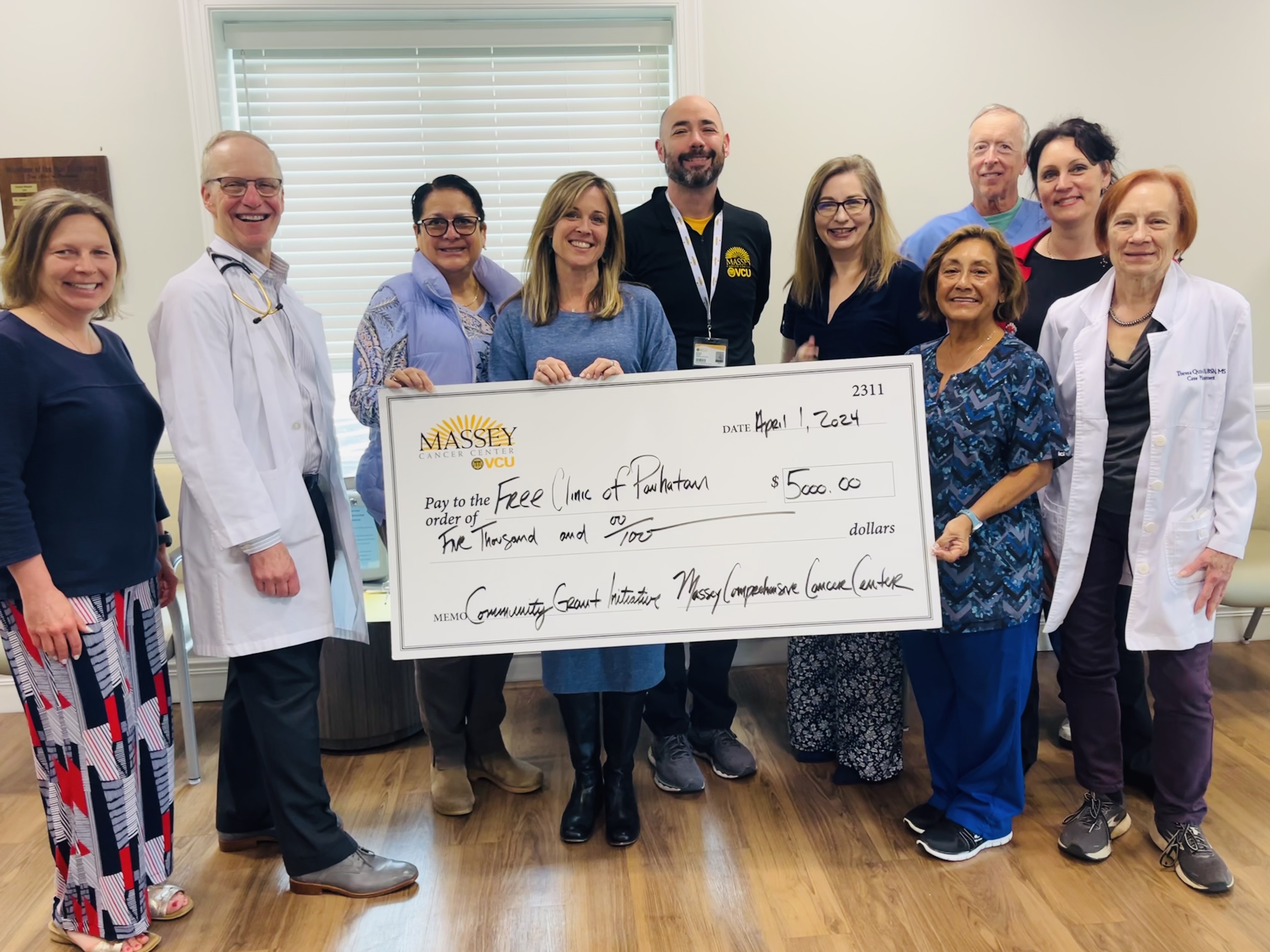 COE staff pictured with grant check at the Free Clinic of Powhatan