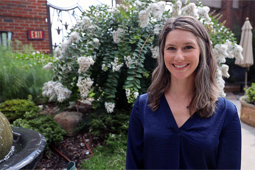 Massey neuroscientist, Sarah Braun, posing in Massey's Healing Garden