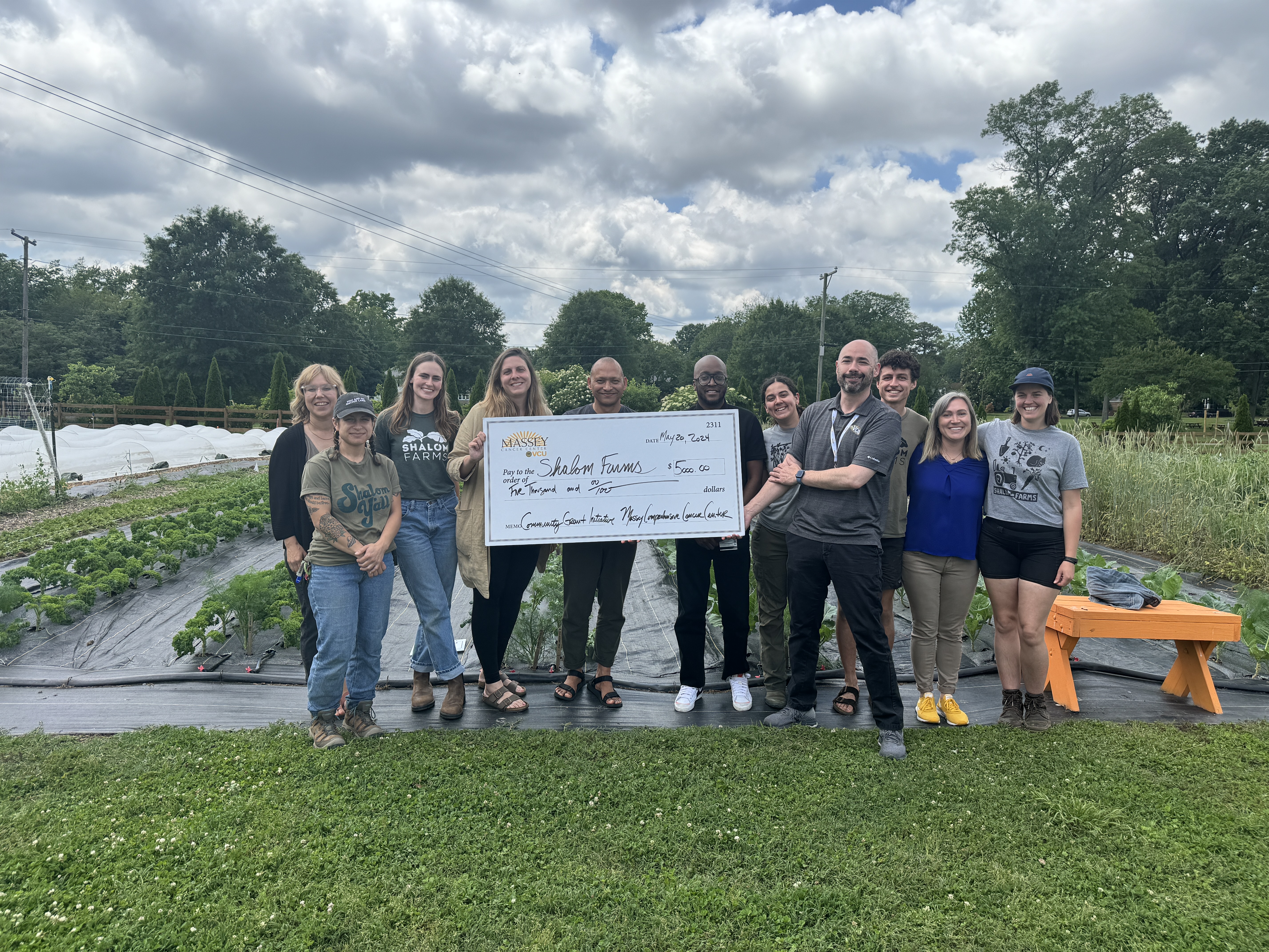 COE staff pictured with grant check at Shalom Farms