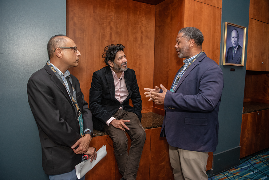 Mukherjee (center) speaks with Massey leadership