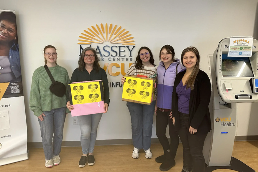 Five VCU students standing with donation boxes