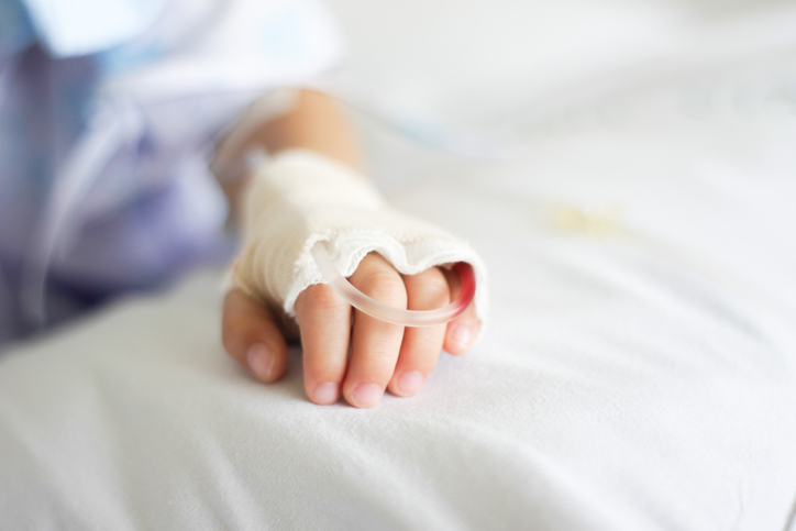 Saline intravenous (iv) drip in a Children's patient hand