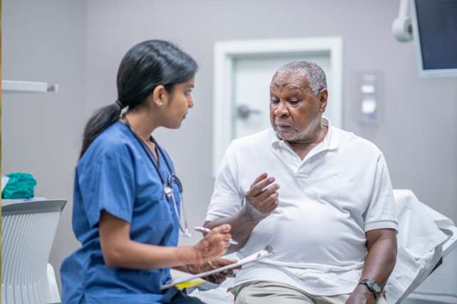 A doctor speaks with a patient