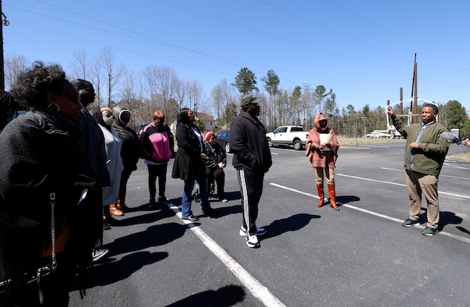 Robert A. Winn, M.D., speaks with community members in parking lot