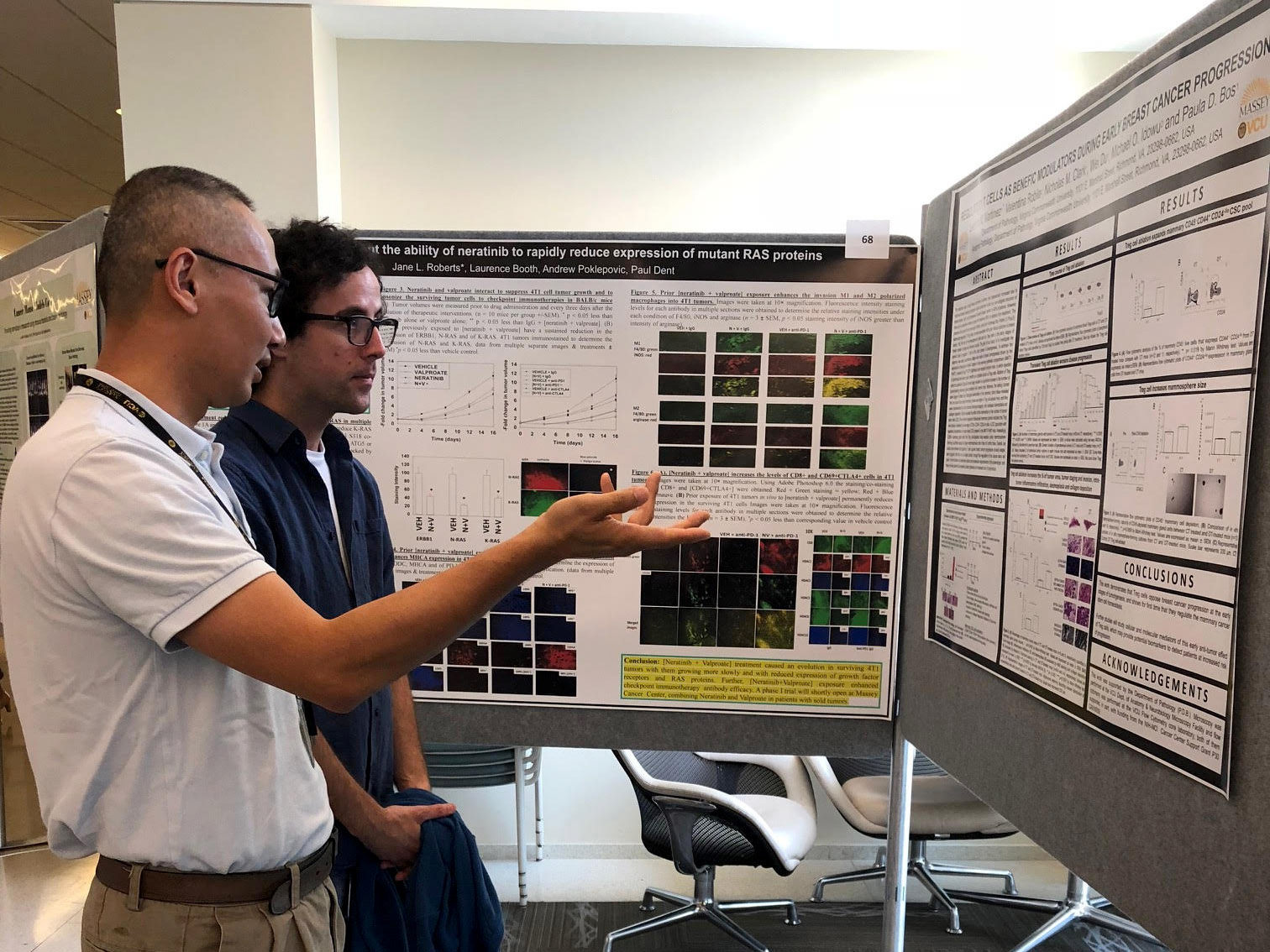 Two participants discussing an abstract at the 2018 Massey Cancer Research Retreat Poster Session