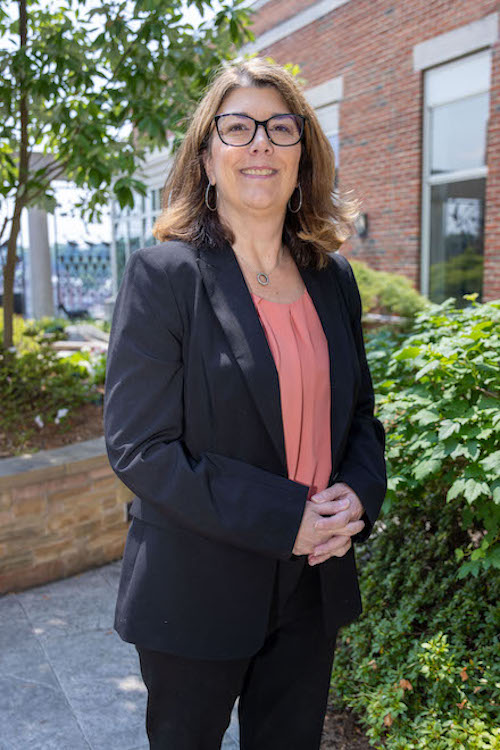 Susan Schreiner standing in a courtyard