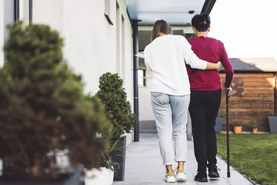 caregiver helping a person walk